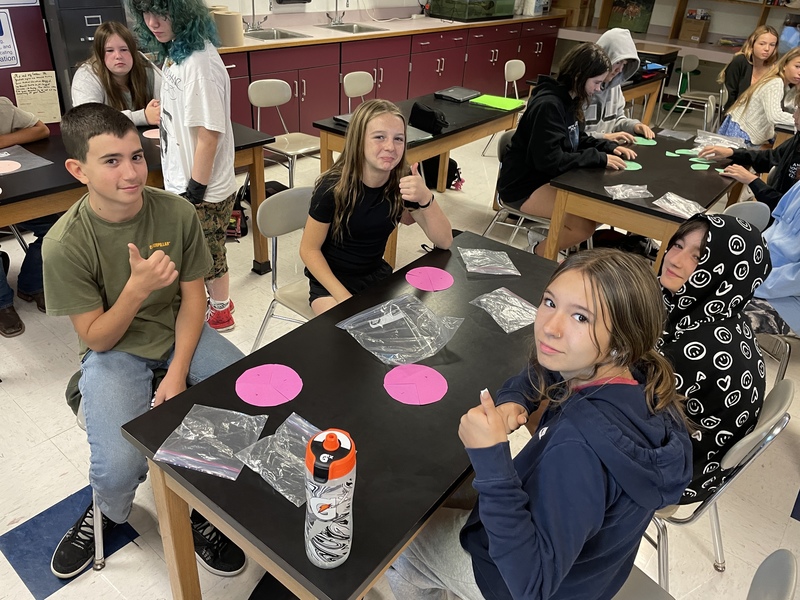 Students participating in broken circles activity
