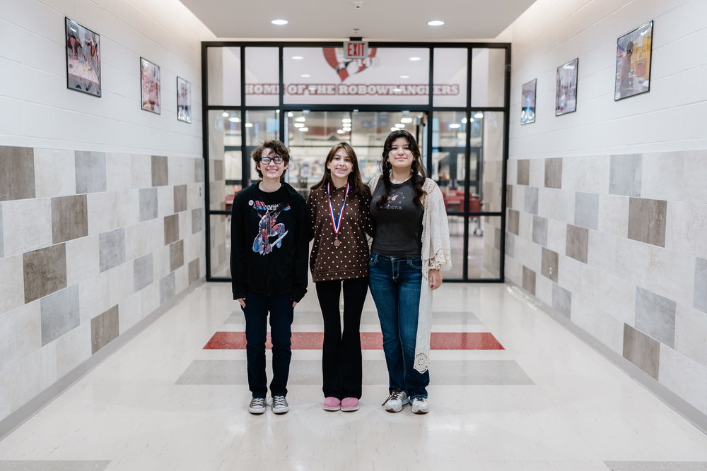 3 People Standing for Photo
