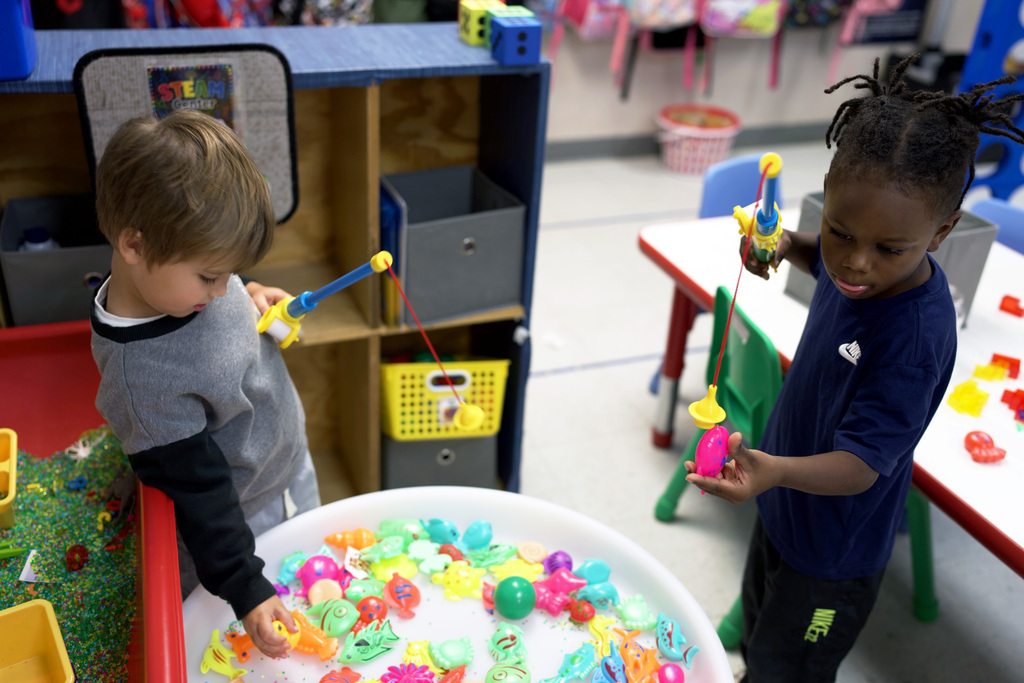 Two young learners play fishing.