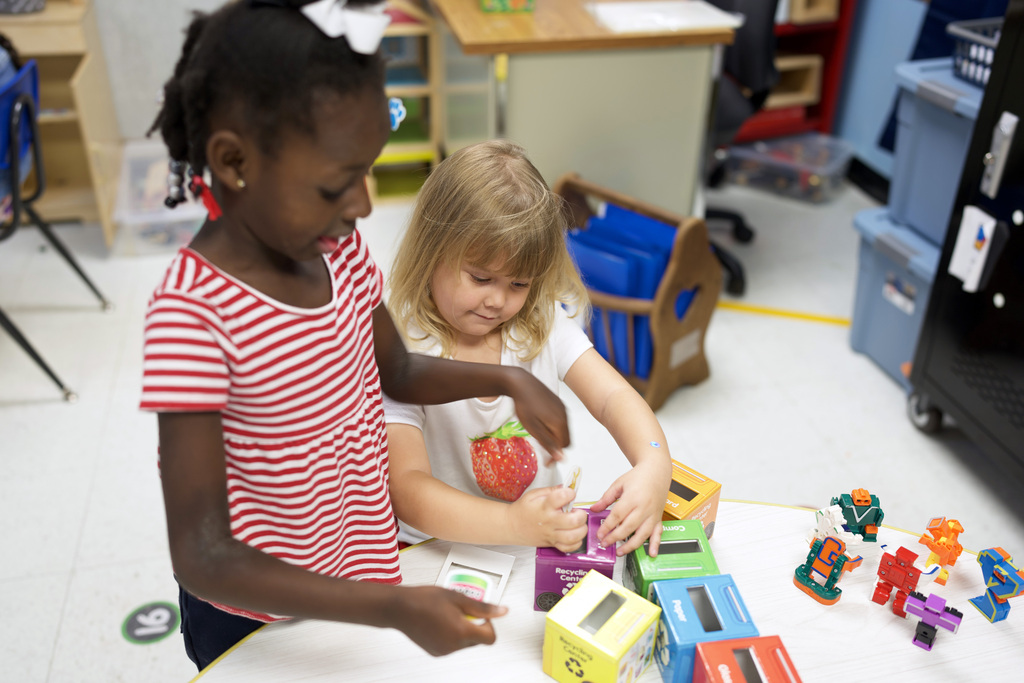 Two young learners playing a matching game.