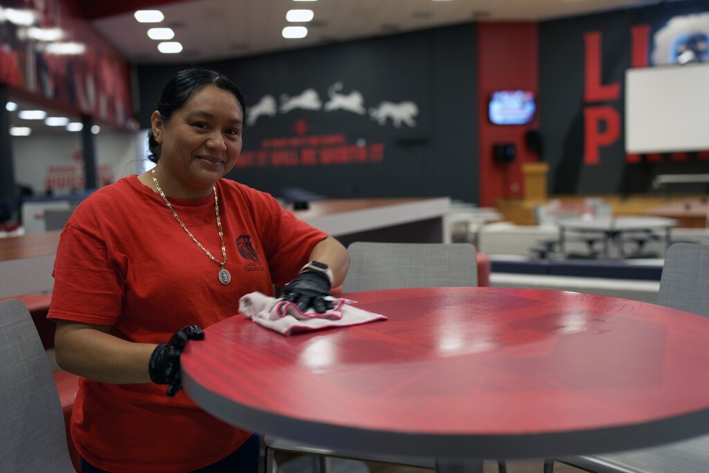 Custodian cleaning tables