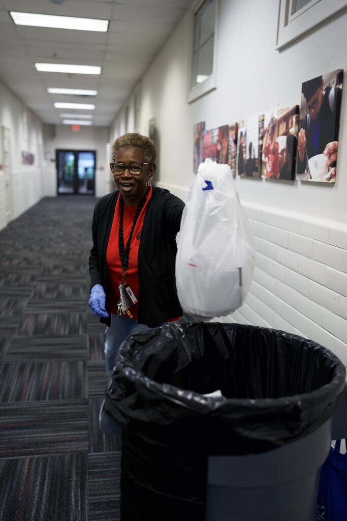 Custodian collecting trash