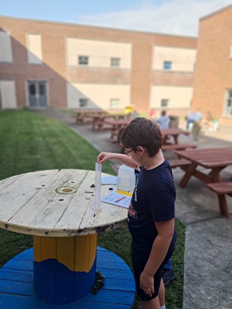 boy putting object in cylinder