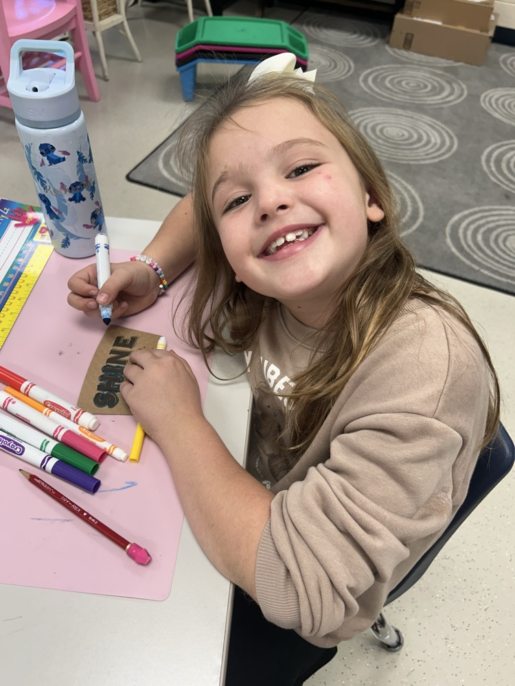 student drawing on shine coffee sleeve