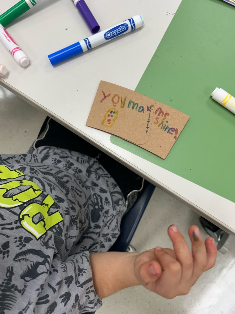 student designed coffee sleeve that says “you make me shine"