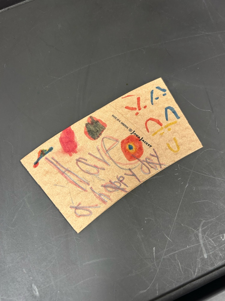 student designed coffee sleeve that says, “have a happy day"