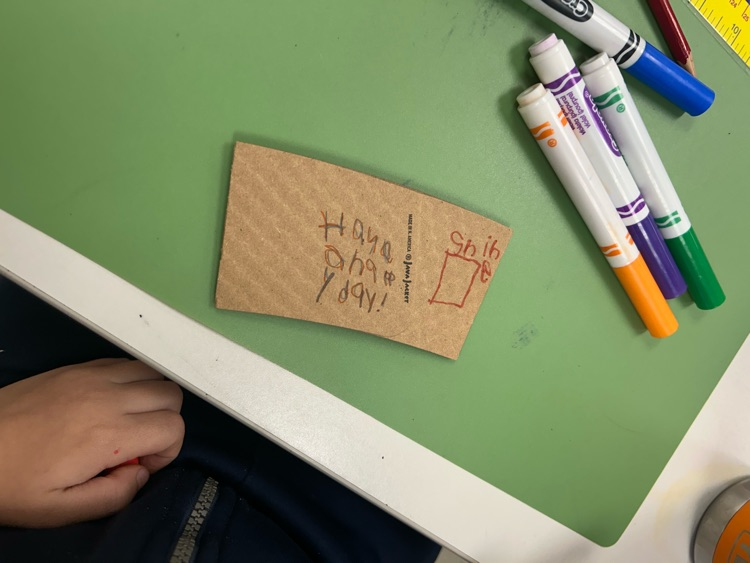 student designed coffee sleeve that says, “have a happy day"