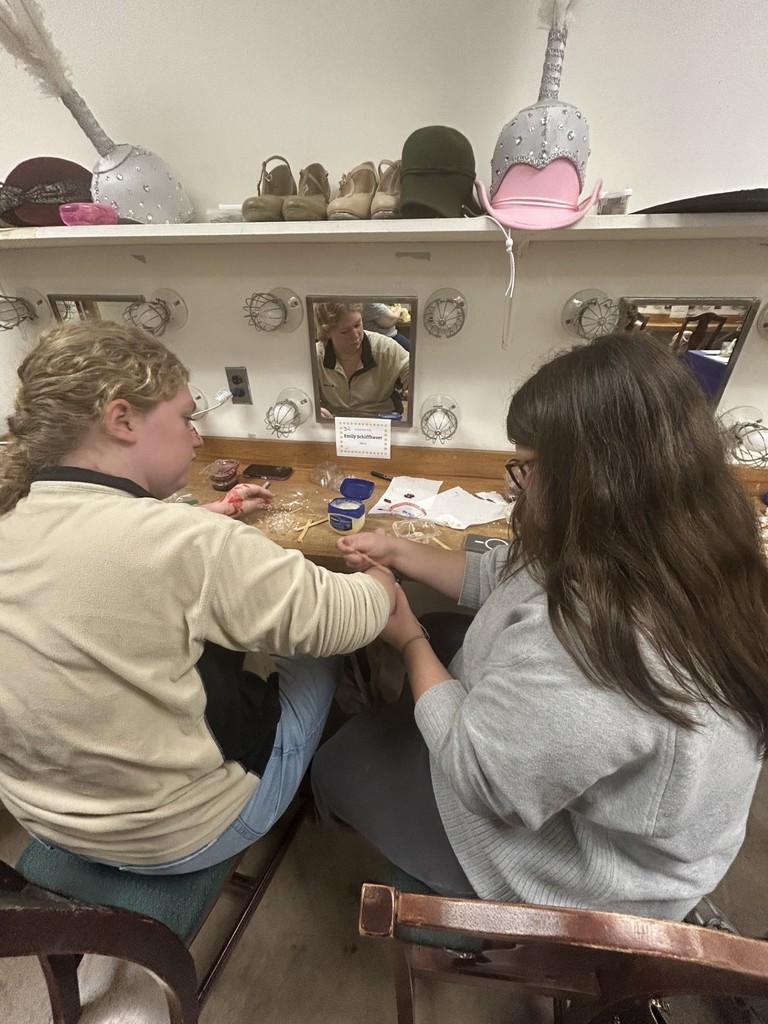 Students learning about special effects makeup techniques.
