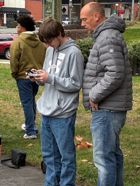 Tyler Moffitt gets instruction from a Harrisburg University Professor on flying a drone equipped with a camera.