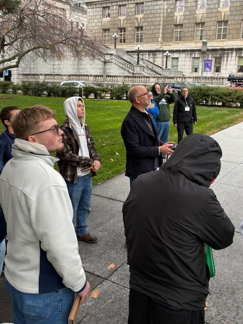 Dalton Trude is learning about a drone equipped with infrared technology from a Harrisburg University Professor.