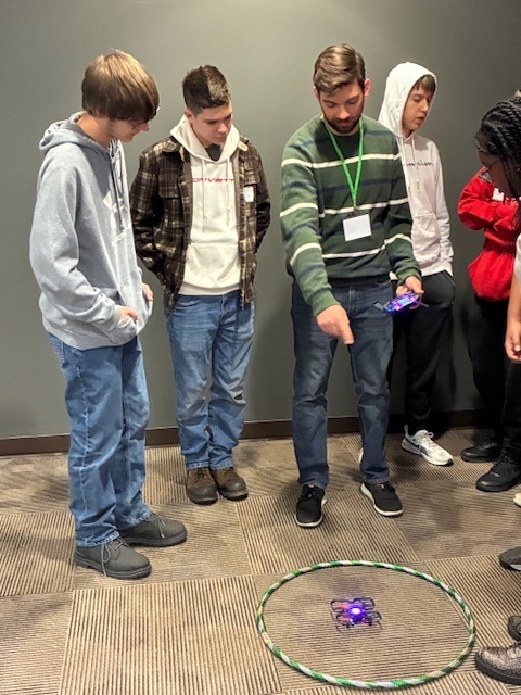 Dalton Trude and Tyler Moffitt learn about the controls for a drone that they will fly through a series of obstacles at Harrisburg University.