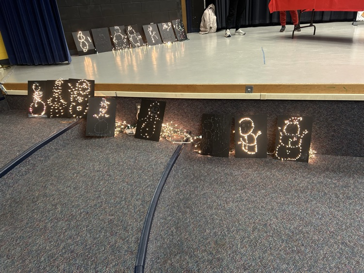 two sets of finished light up snowman showcased on the stage and in front of the stage