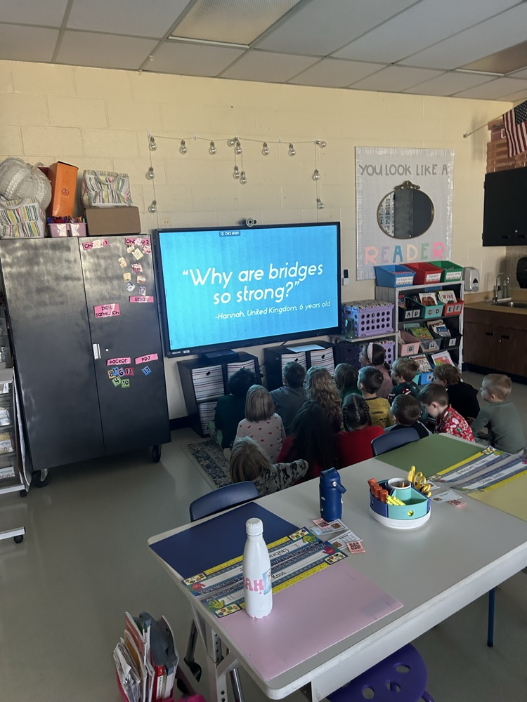 first grade students watching an educational video on bridges 