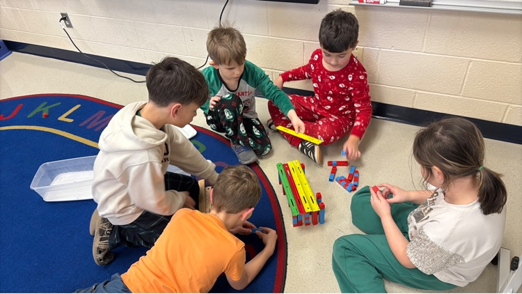 5 students use snap cubes and rulers to create a bridge 