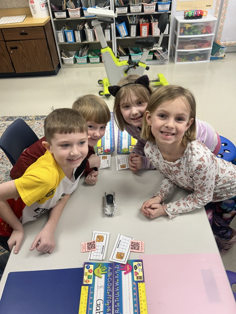 four friends smile together with their completed bobsleigh 