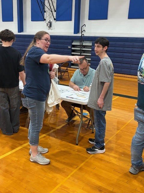 Blake Harper gets some direction from Mrs. Shay at Belco Credit Union's Reality Fair.