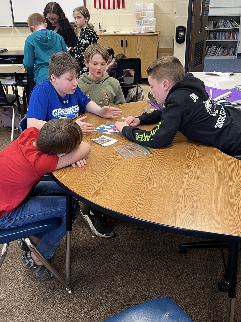 Students building quilt patterns in class.