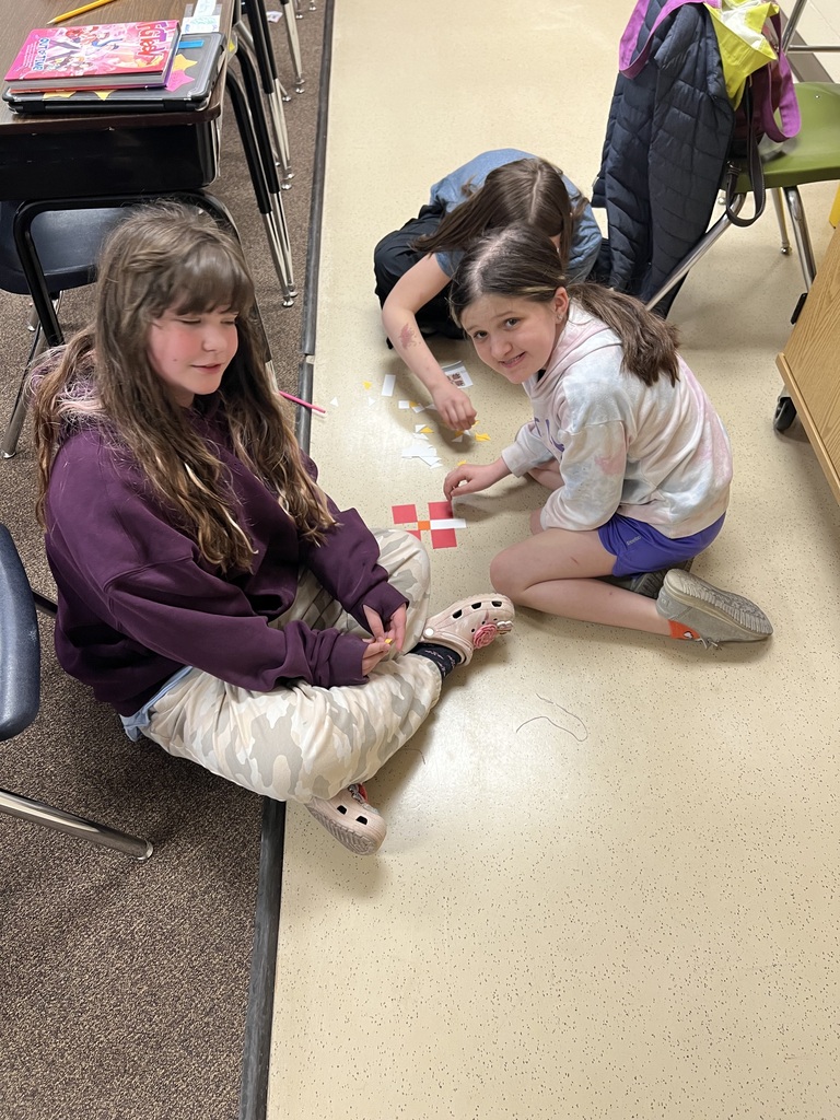 Students building quilt patterns in class.