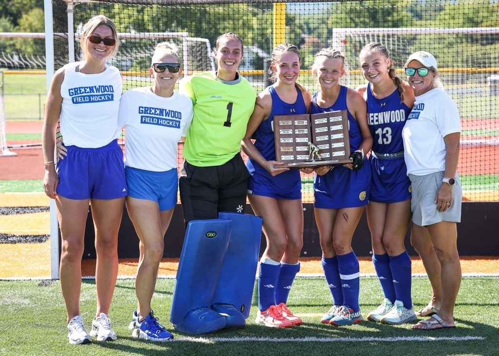 Field Hockey Players Holding Trophy