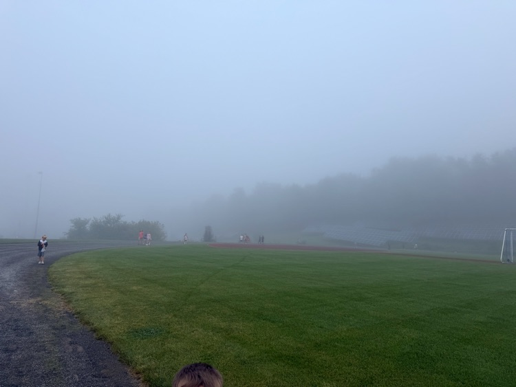 students walking the track in fog
