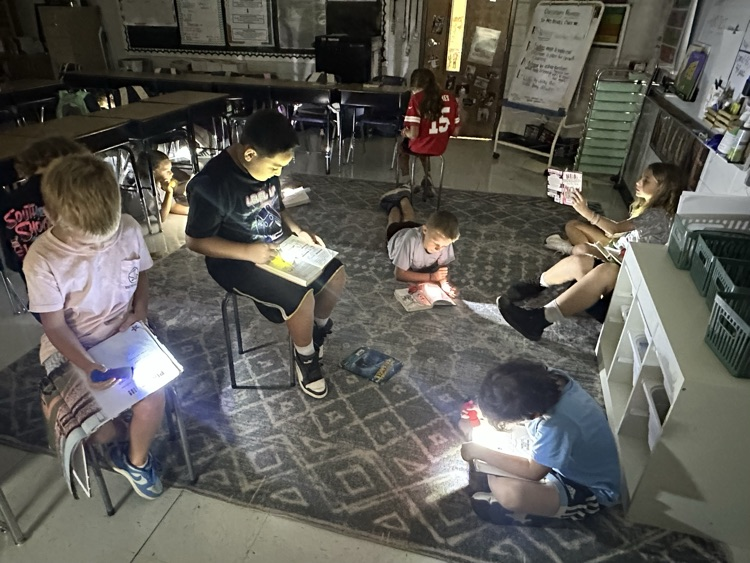 Kids reading by flashlight in fourth grade