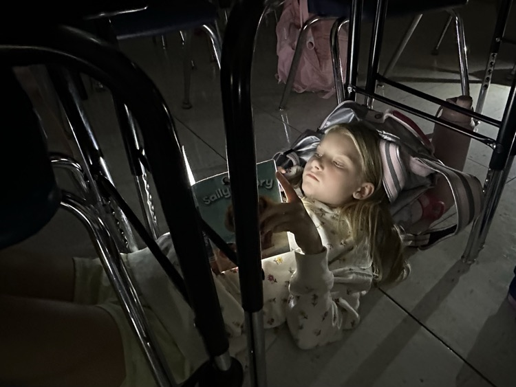 Kids reading by flashlight in fourth grade