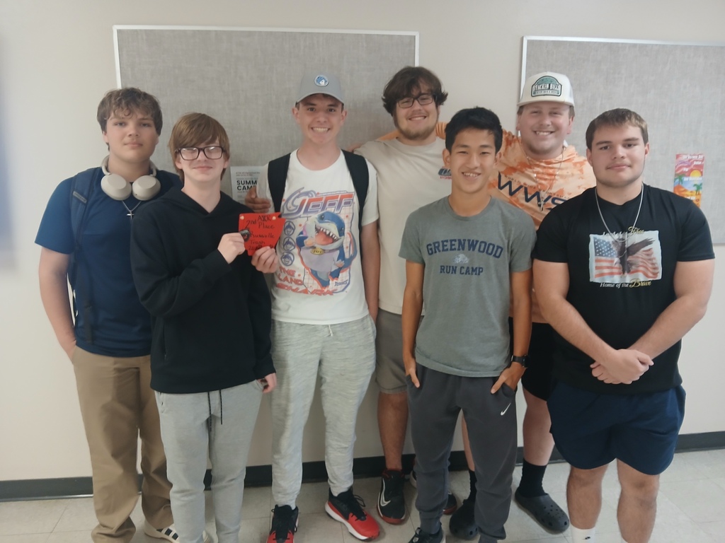 students standing with a trophy