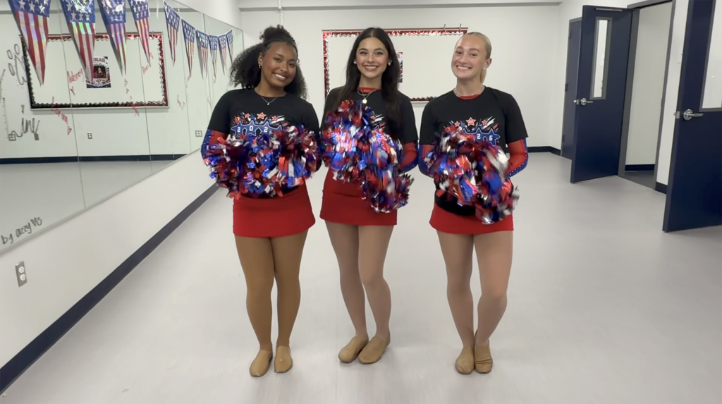 Three girls dressed in uniform