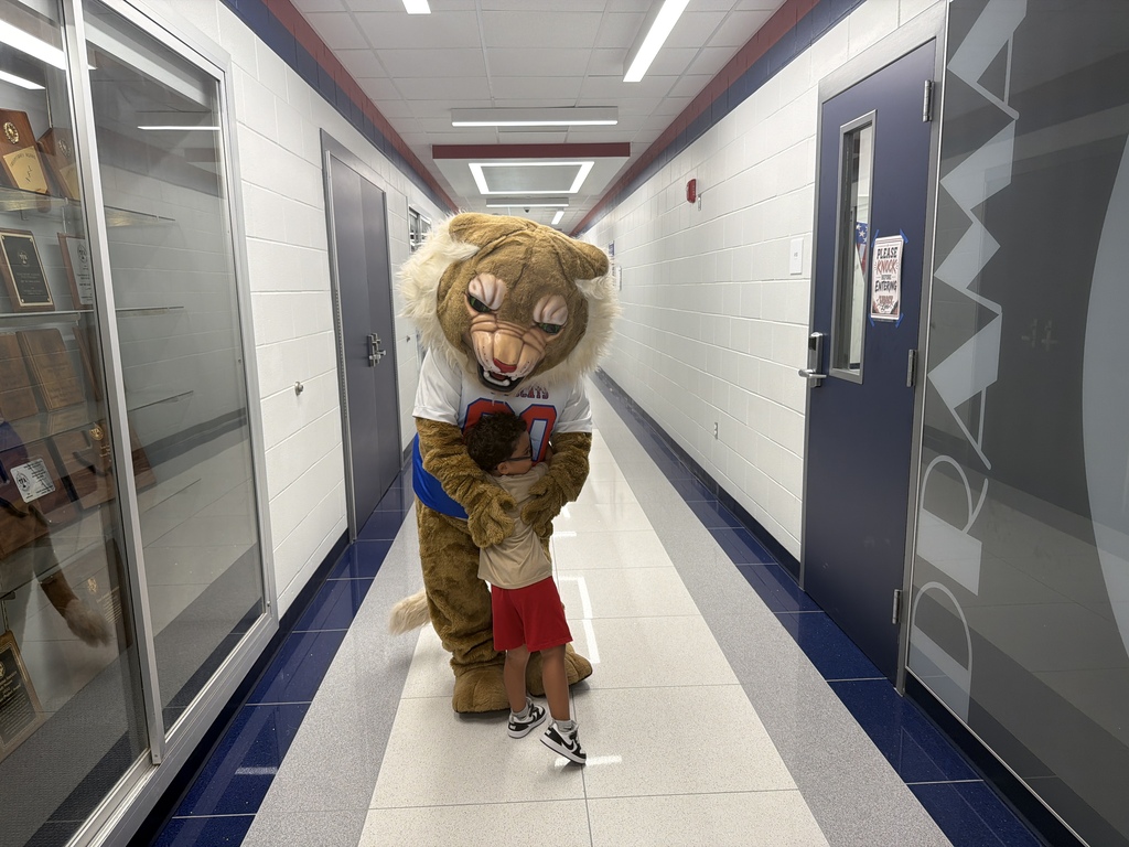 G-P wildcat hugging a young boy 