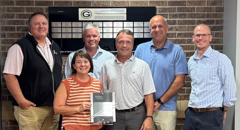 photo of the board of education members holding award with a plaque of all awards received for 20 consecutive years 30 total