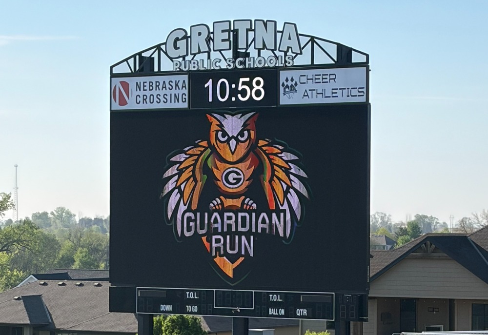 Gretna High School scoreboard with the Gretna Guardians logo and text reading Guardian Run