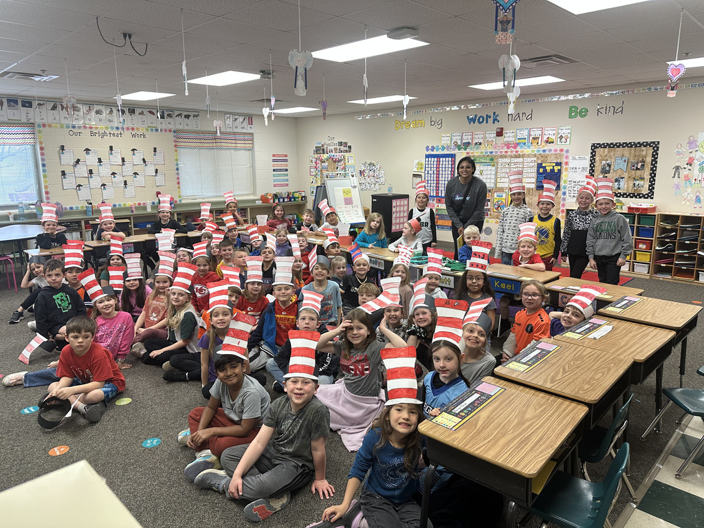 1st grade students seated and pictured with Kayla Caffey of the Omaha Supernovas in a 1st grade classroom.