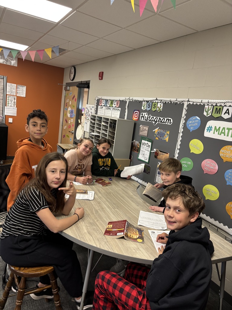 students sit together and share a novel in a group literature circle