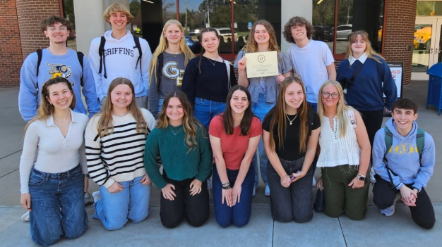 A group of Gretna East journalism students pose with their certificate winning the Division B Journalism Program of the Year at University of Nebraska Omaha
