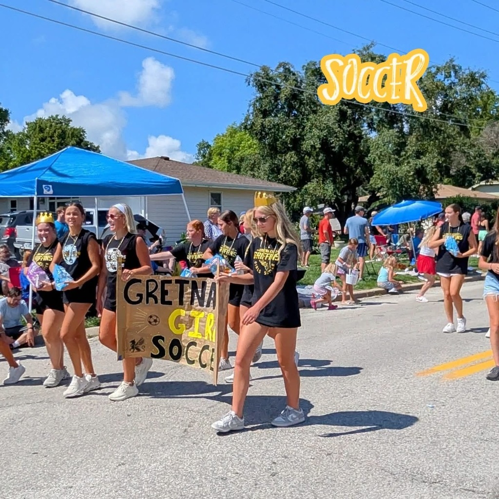 Gretna East soccer girls walking in Gretna Days parade with a sign reading Gretna Girls Soccer