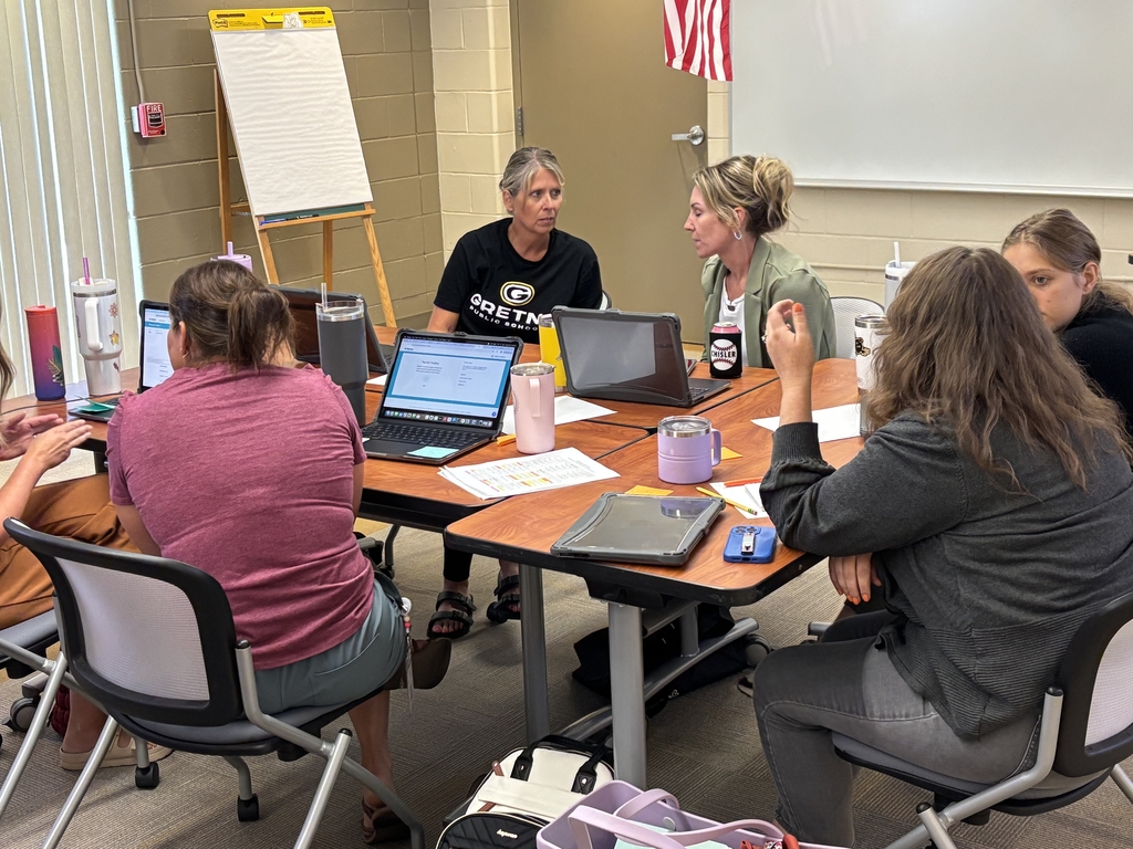 new staff gathered around tables in conference rooms in discussion and collaboration