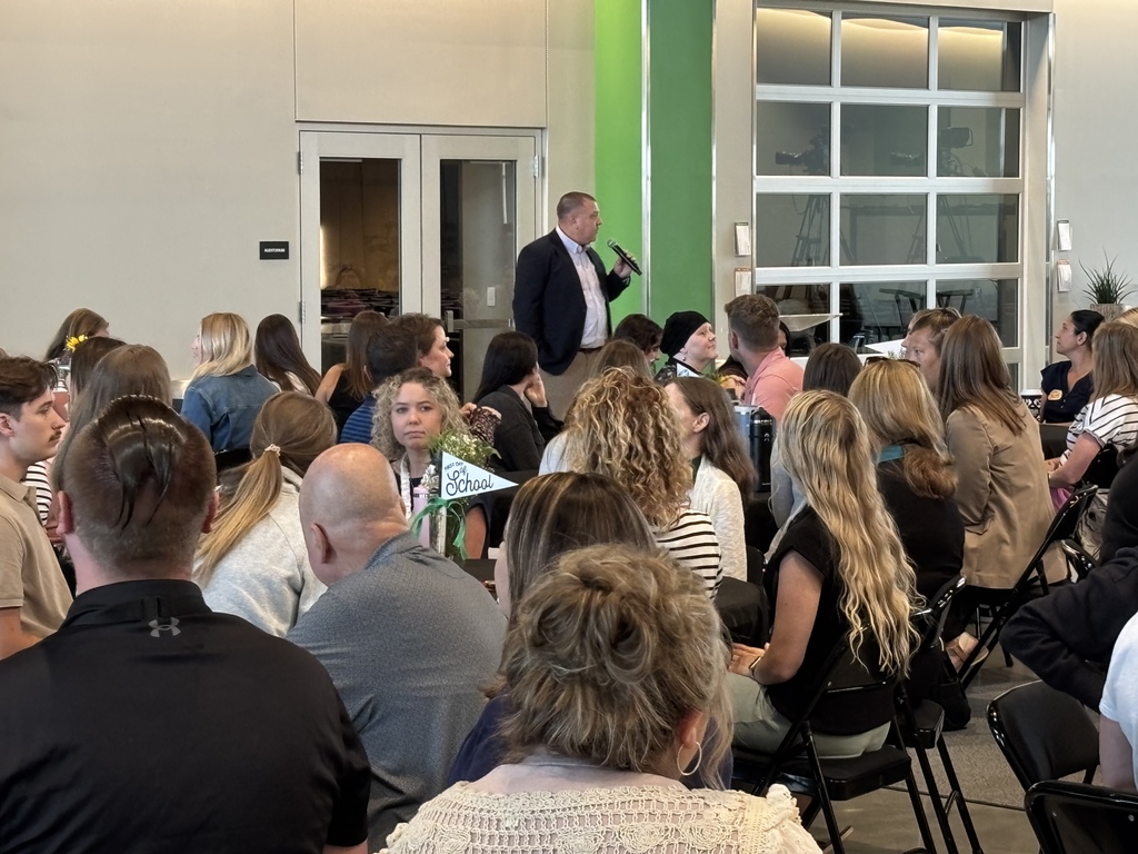 Superintendent Travis Lighte standing in front of staff members at Journey Church speaking to the new staff