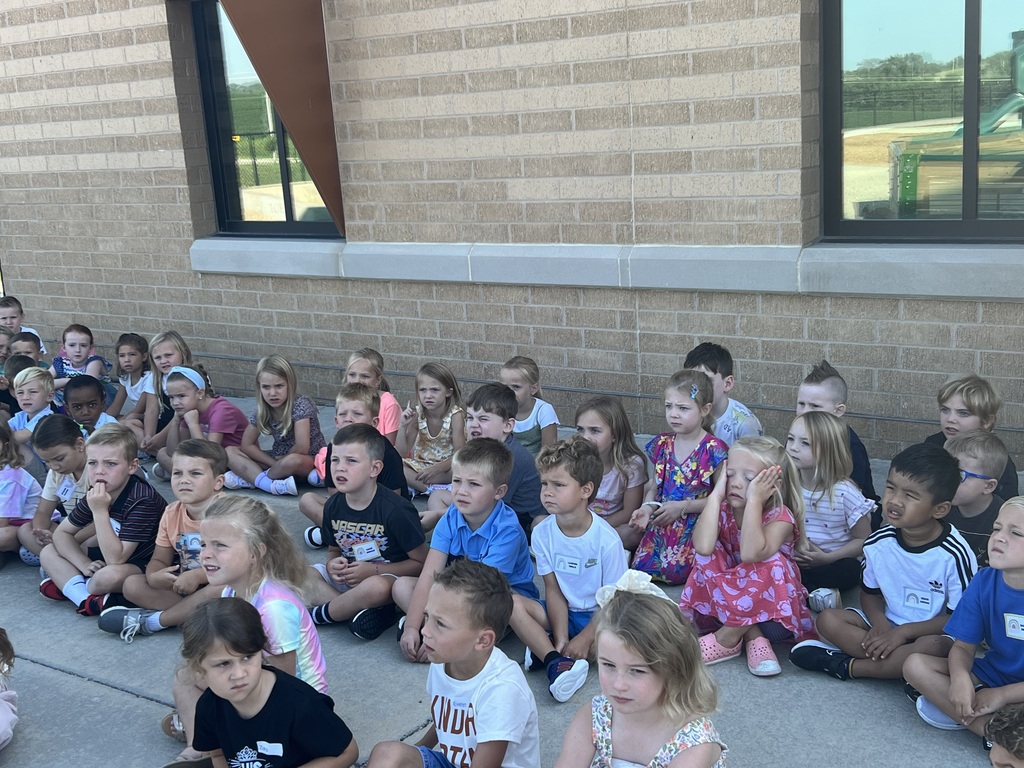 students sit on the concrete at recess