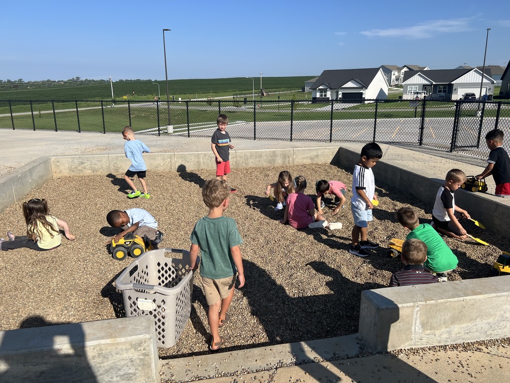 students play in the sand pit