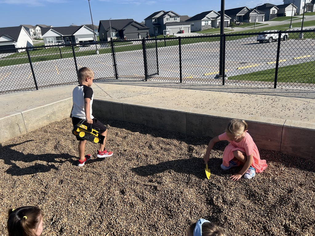students play in the sandpit