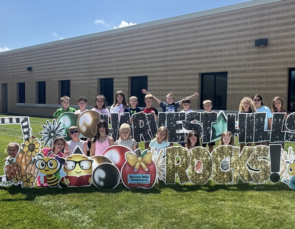 students smiling for a picture outside for the first day of school