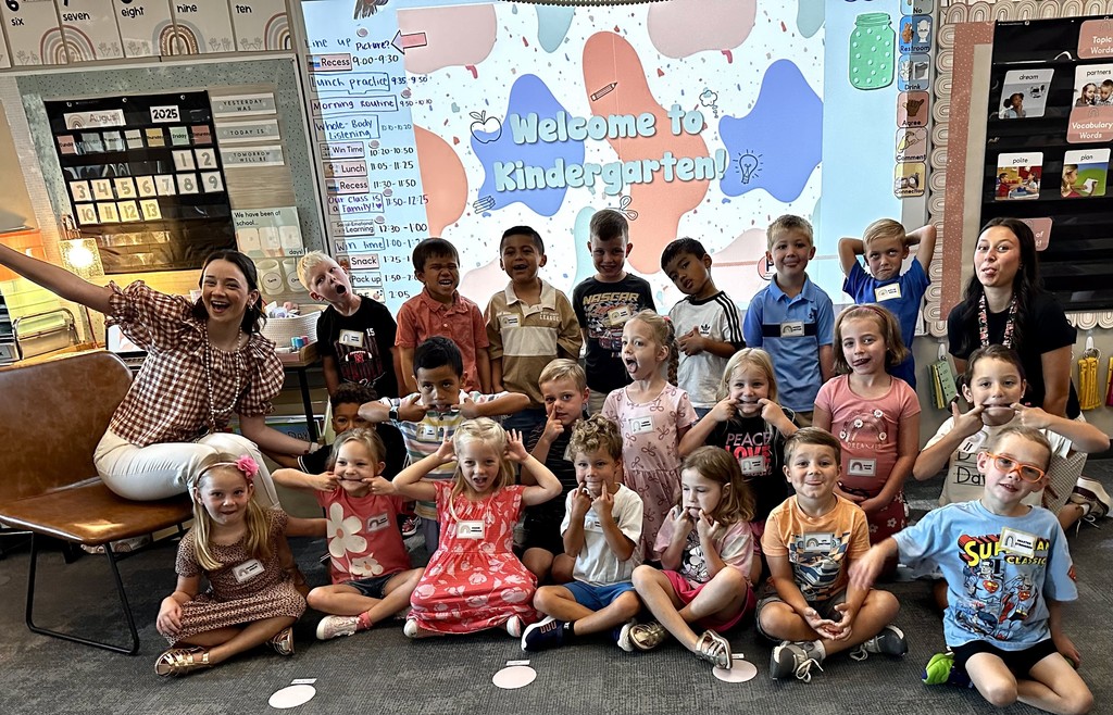 students smiling for a picture outside for the first day of school