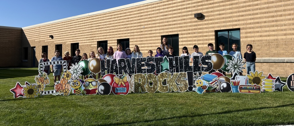 students smiling for a picture outside for the first day of school