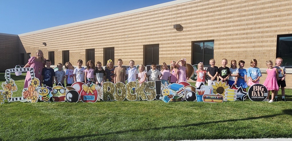 students smiling for a picture outside for the first day of school