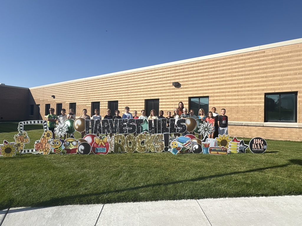 students smiling for a picture outside for the first day of school