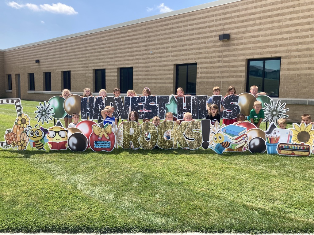 students smiling for a picture outside for the first day of school