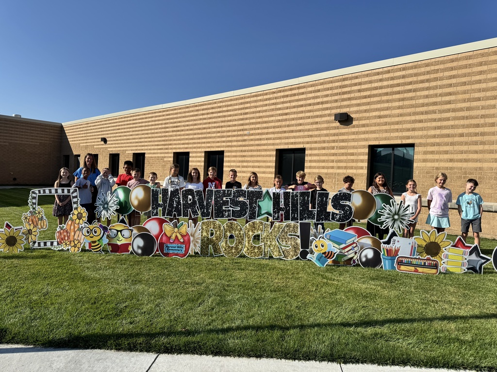 students smiling for a picture outside for the first day of school