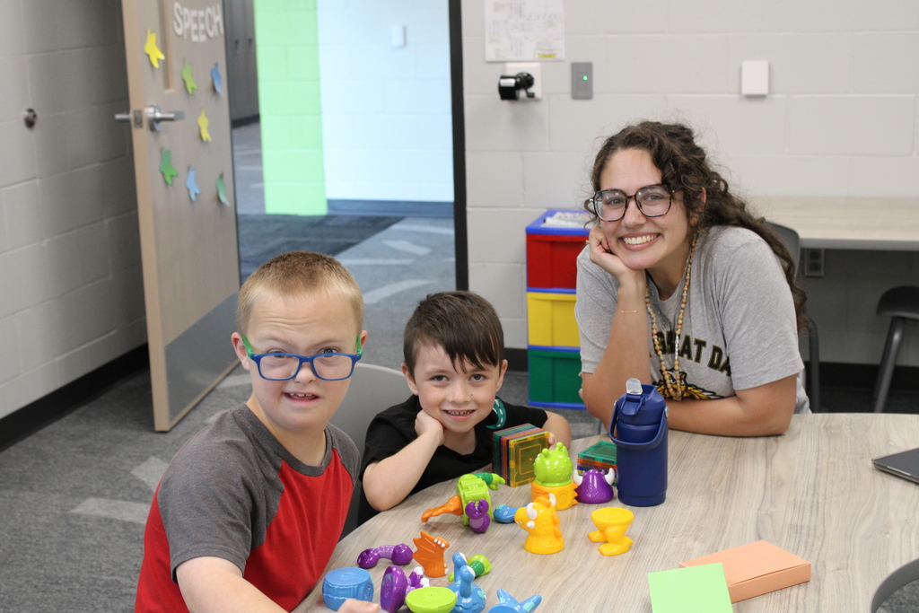 Ms. Glasshoff and two students engage in a fun activity together!