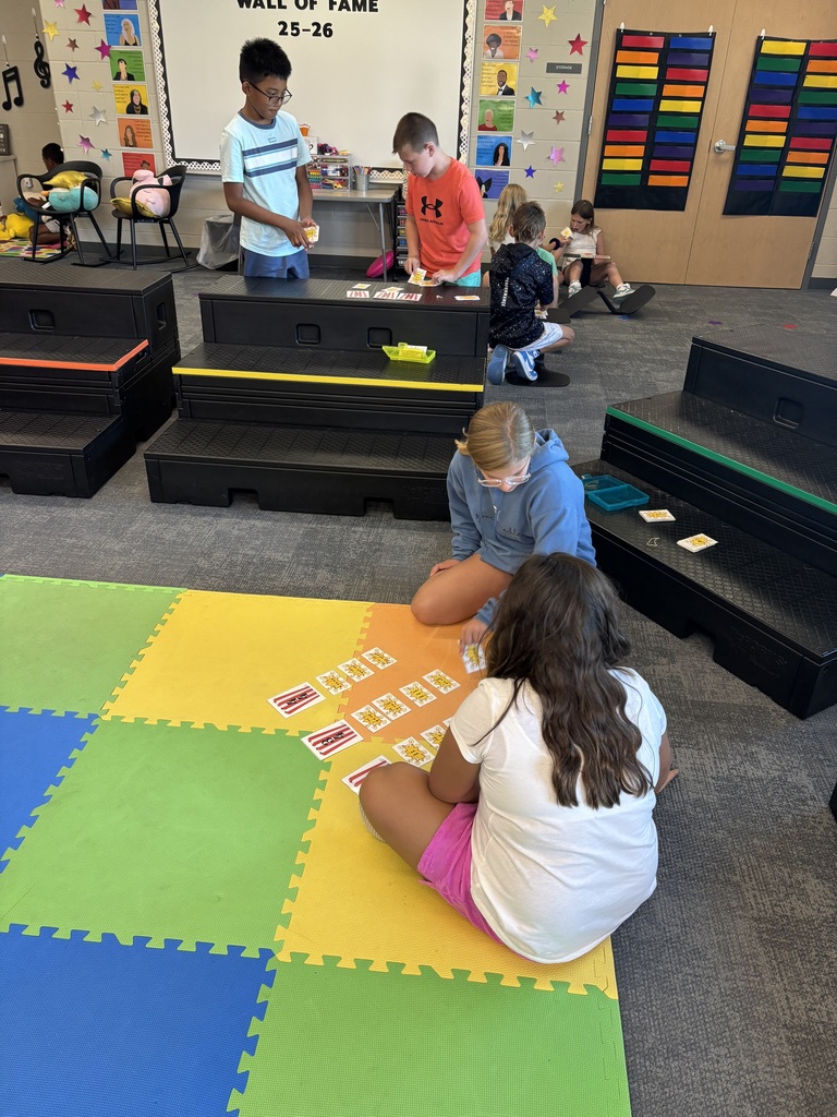 Students playing a card game on the floor