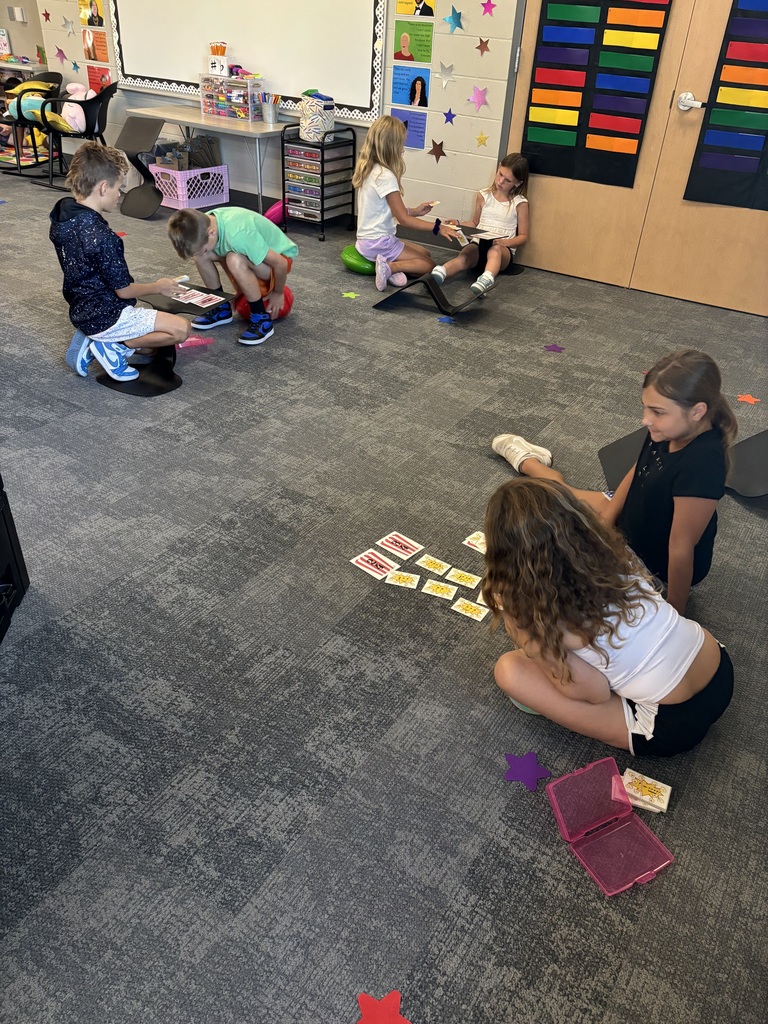 Students playing a card game on the floor
